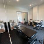 Comfortable private consultation room set up for chiropractic care, featuring treatment table and natural light.